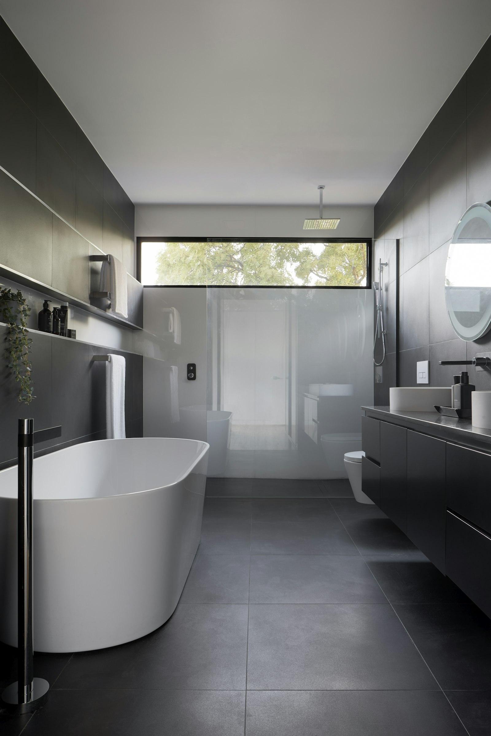 Bathroom with tub, shower, tiling and vanity