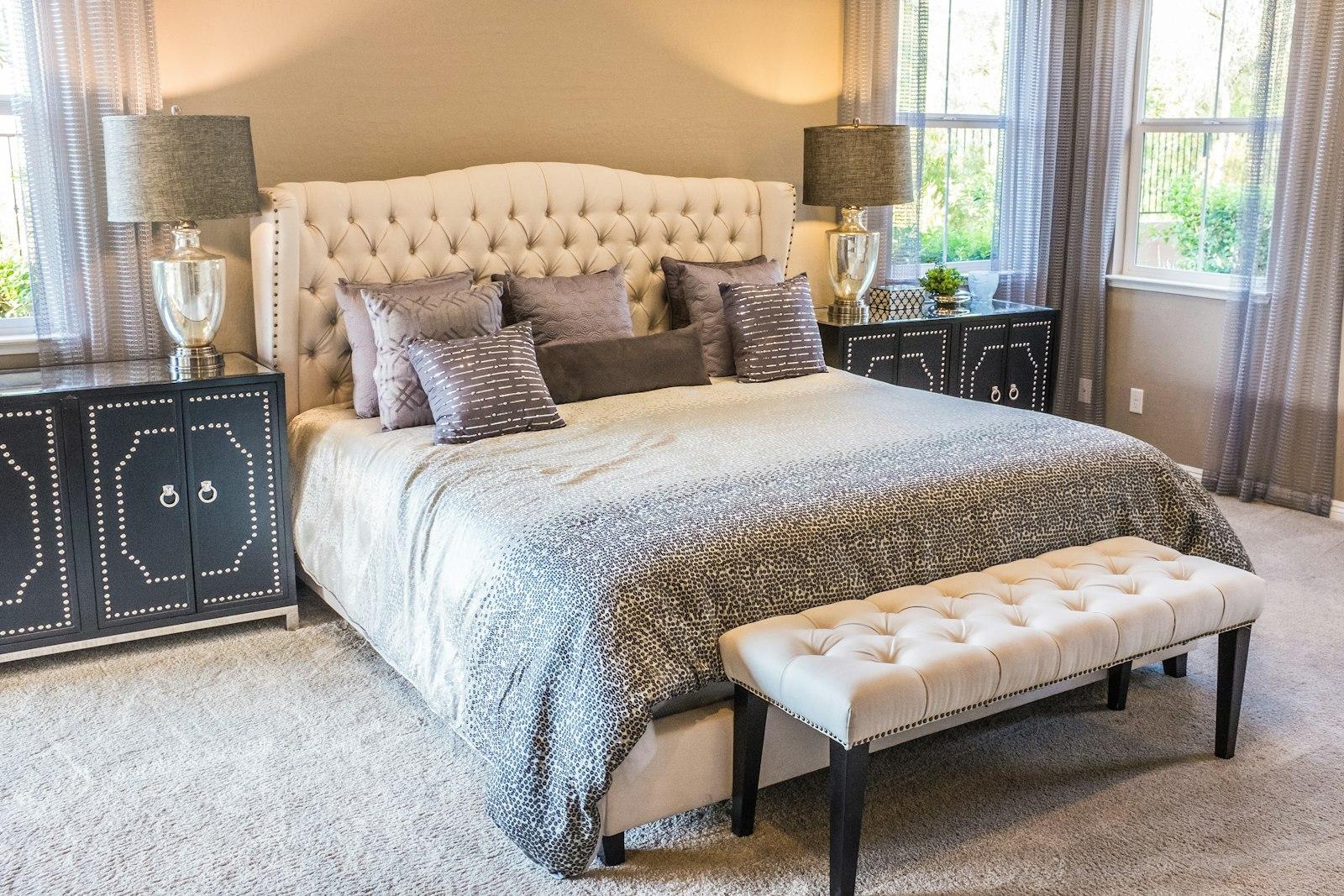 Bedroom with sheer curtains and upholstered bed